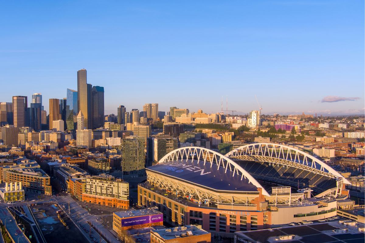 Aerial view of Lumen Field and the downtown Seattle skyline, highlighting the city’s sports and urban community.