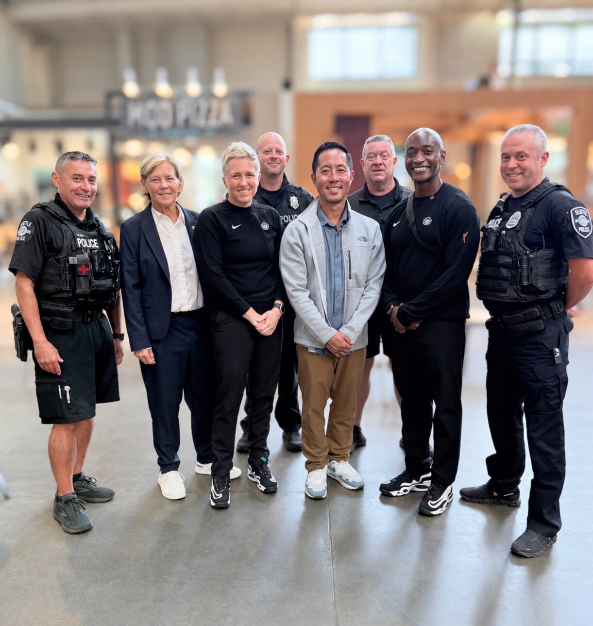 Group of Seattle police officers and community guests posing together at an event